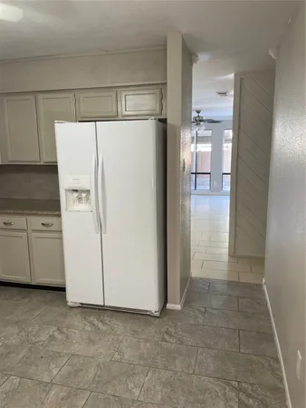 a white refrigerator freezer sitting inside of a kitchen
