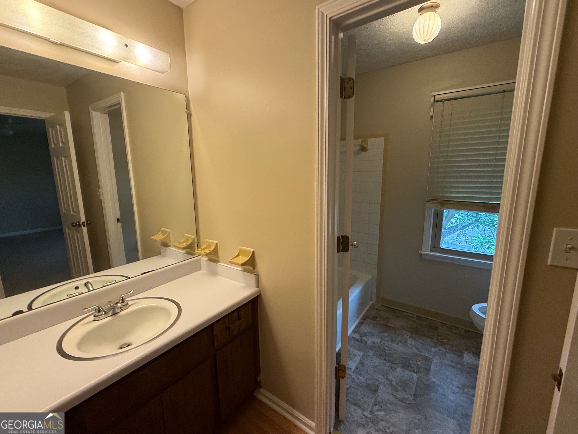 2691 Falcon Ridge Drive Southwest Grayson, GA 30017 - Photo 6 of 10 a bathroom with a granite countertop sink and a mirror