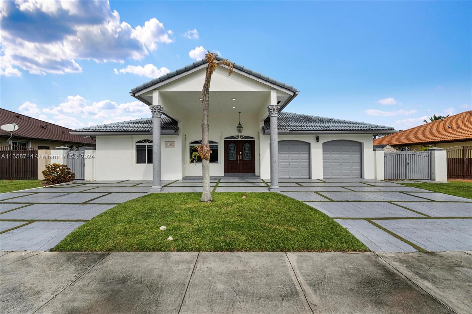 3209 Southwest 142nd Place Miami, FL 33175 - Photo 1 of 42 a front view of a house with a yard