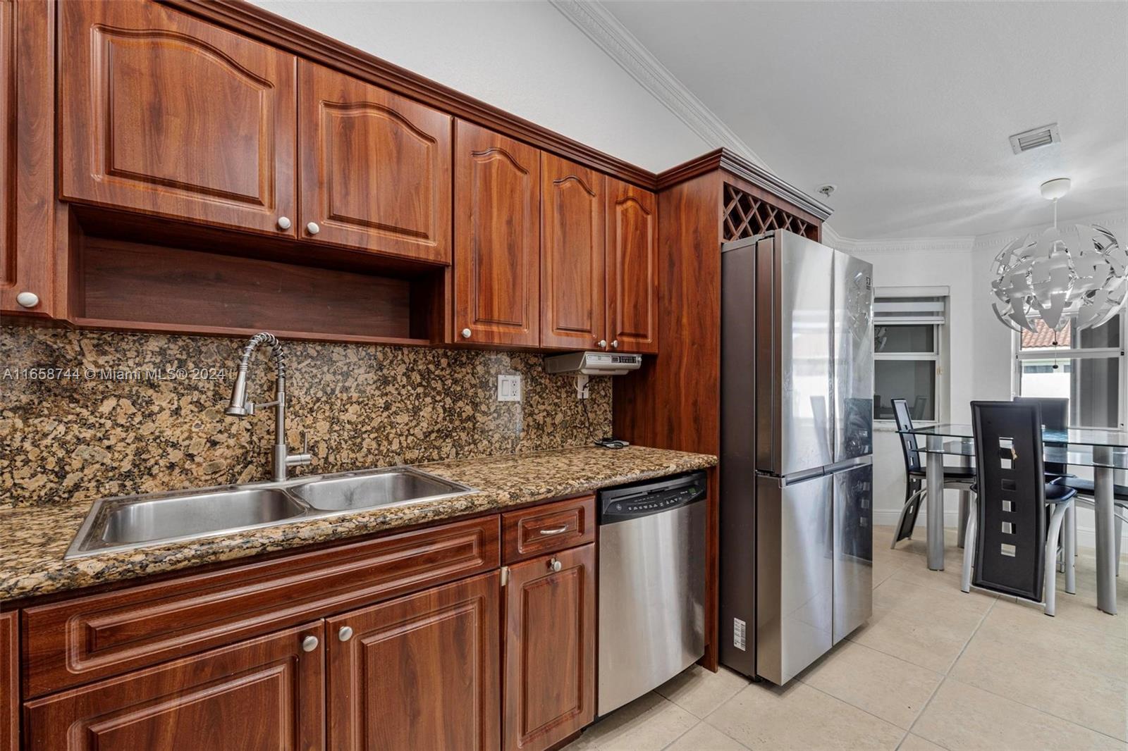3209 Southwest 142nd Place Miami, FL 33175 - Photo 14 of 42 a kitchen with stainless steel appliances granite countertop a refrigerator and a sink