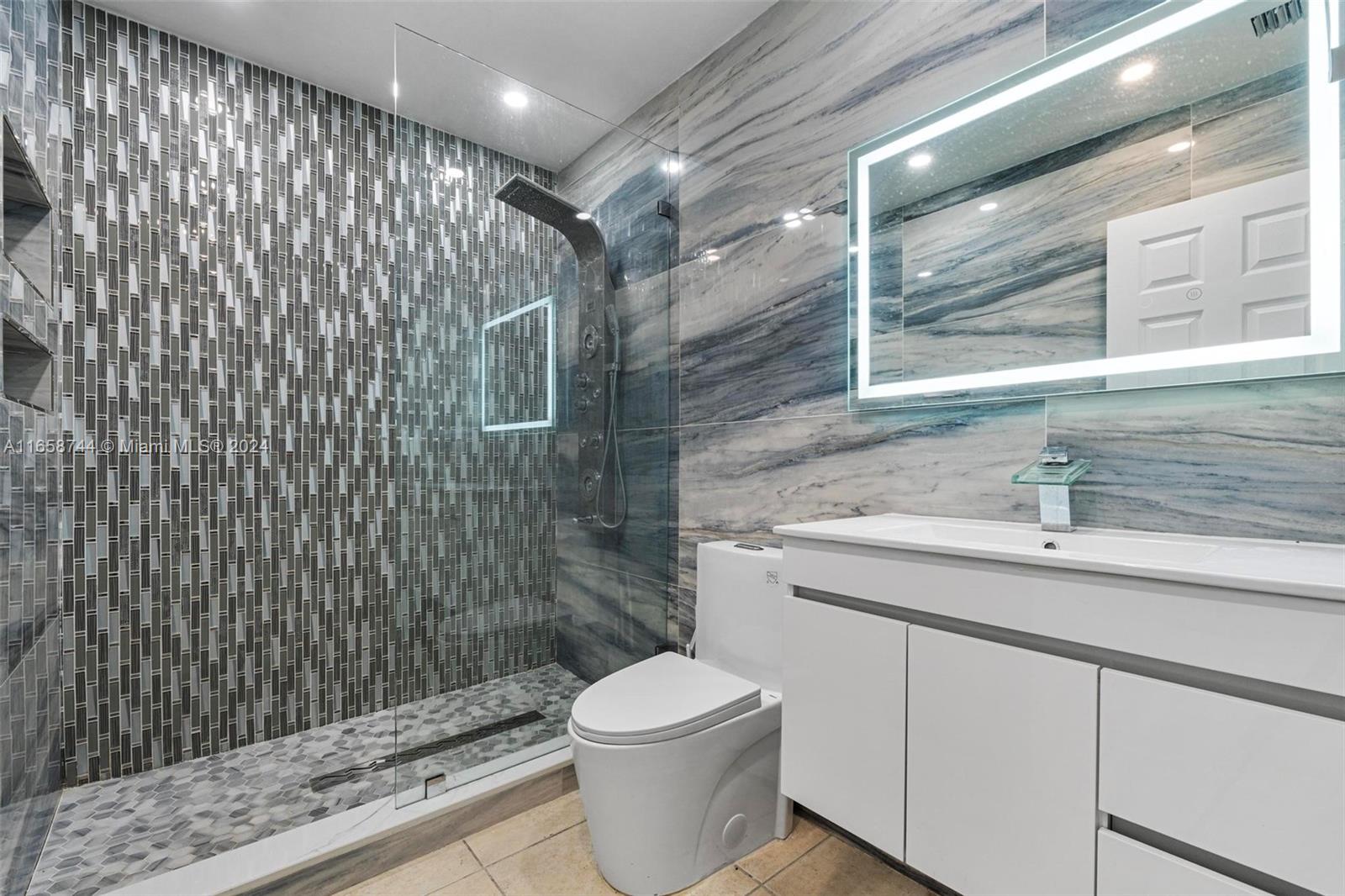 3209 Southwest 142nd Place Miami, FL 33175 - Photo 15 of 42 a bathroom with a sink toilet and shower