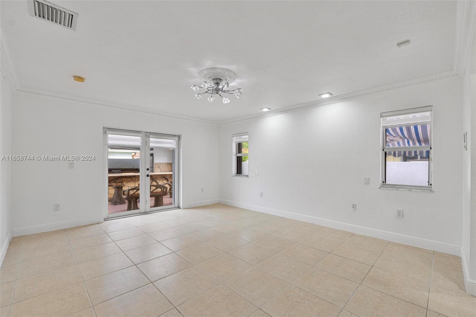 3209 Southwest 142nd Place Miami, FL 33175 - Photo 18 of 42 an empty room with windows and cabinet