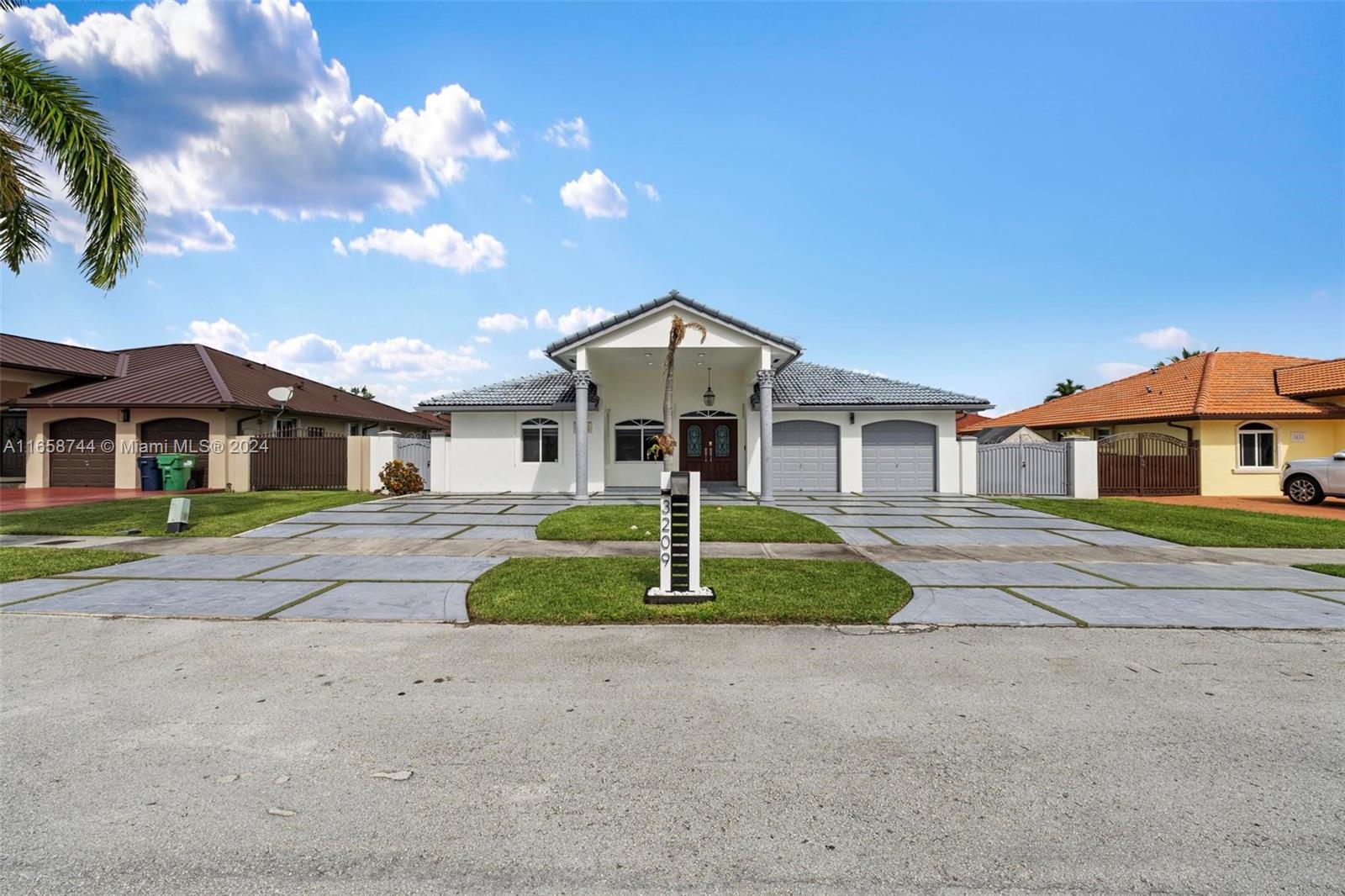 3209 Southwest 142nd Place Miami, FL 33175 - Photo 2 of 42 a front view of a house with a yard
