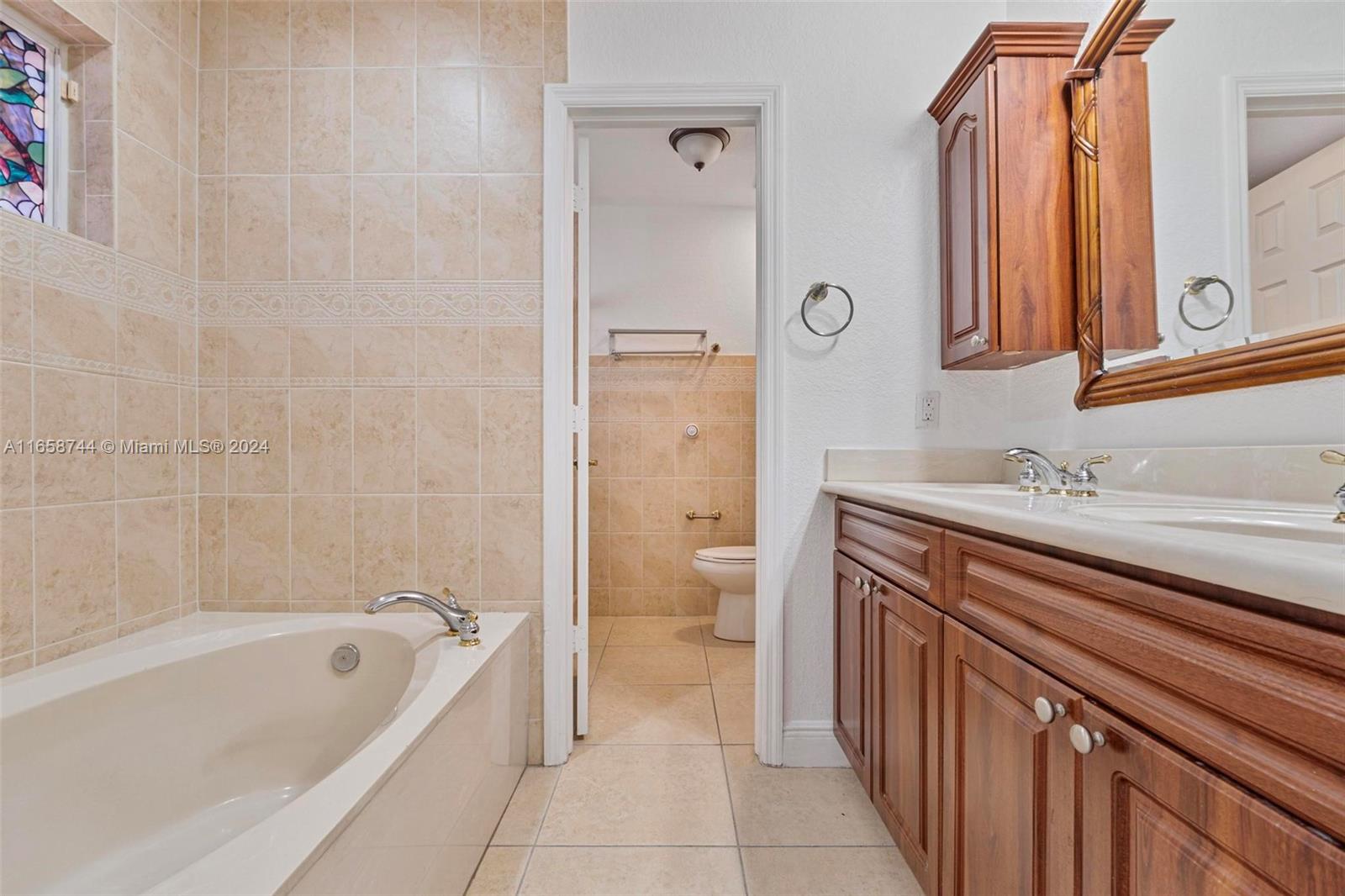 3209 Southwest 142nd Place Miami, FL 33175 - Photo 21 of 42 a bathroom with a granite countertop sink a toilet and shower