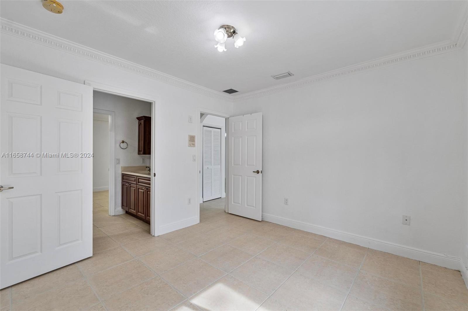 3209 Southwest 142nd Place Miami, FL 33175 - Photo 24 of 42 a view of a kitchen with refrigerator and white wall