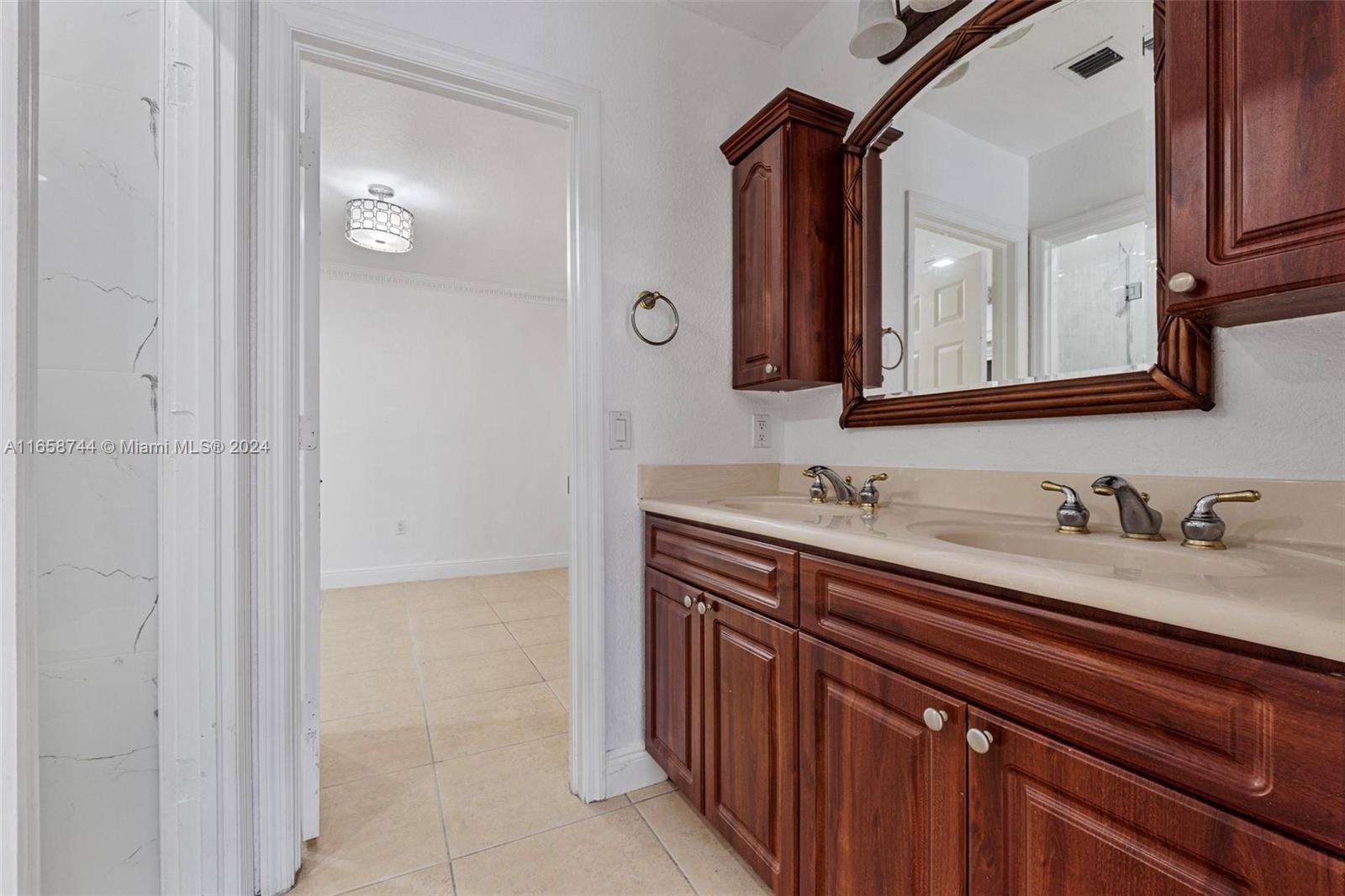 3209 Southwest 142nd Place Miami, FL 33175 - Photo 25 of 42 a bathroom with a sink and a mirror