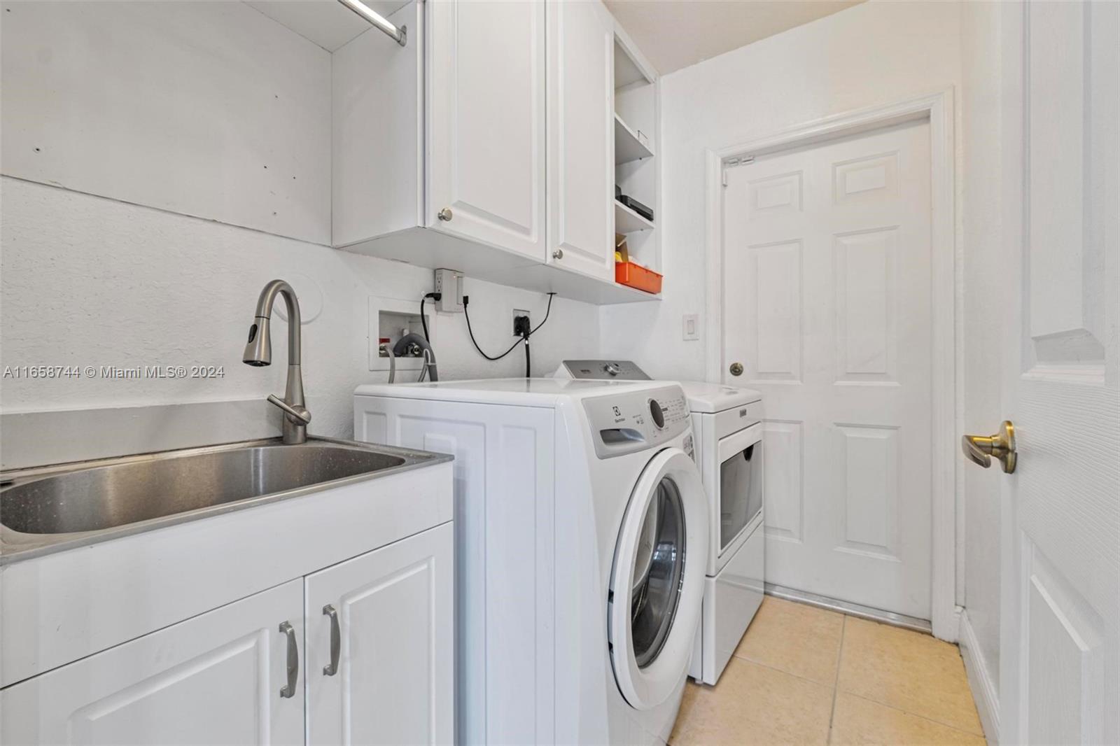 3209 Southwest 142nd Place Miami, FL 33175 - Photo 30 of 42 a utility room with dryer and washer