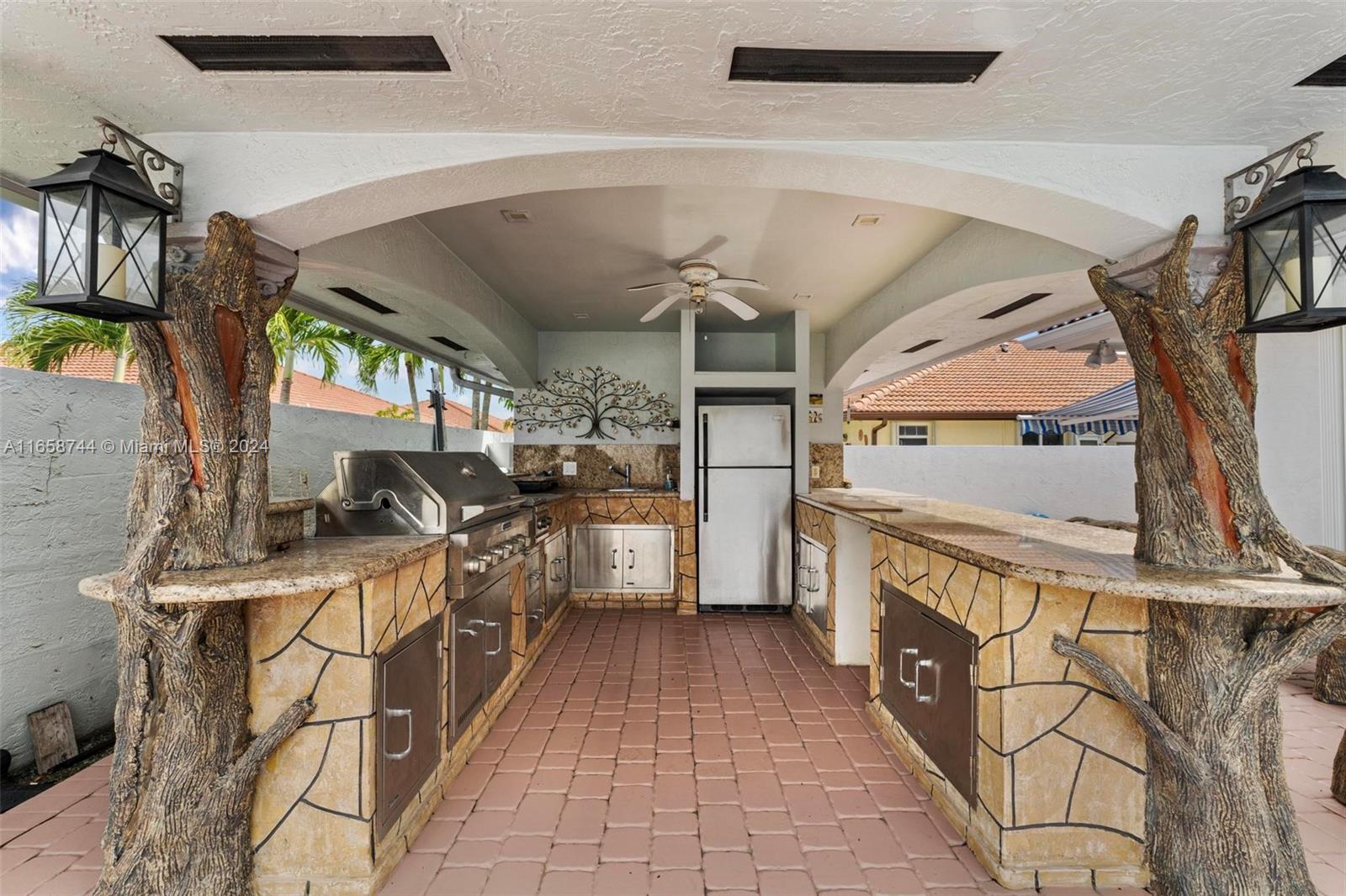 3209 Southwest 142nd Place Miami, FL 33175 - Photo 32 of 42 a kitchen with a sink a stove and cabinets