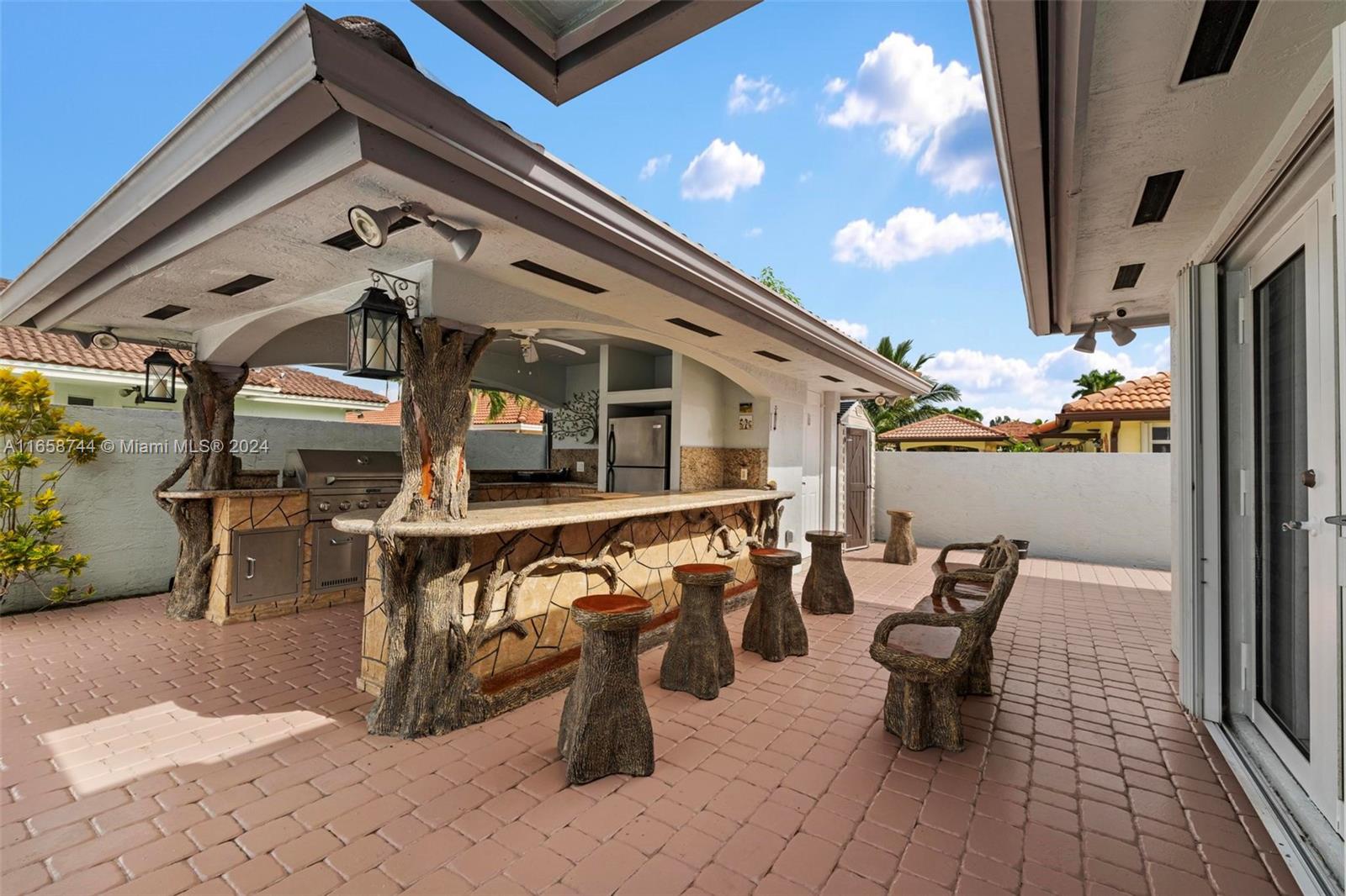 3209 Southwest 142nd Place Miami, FL 33175 - Photo 34 of 42 a view of a patio with table and chairs