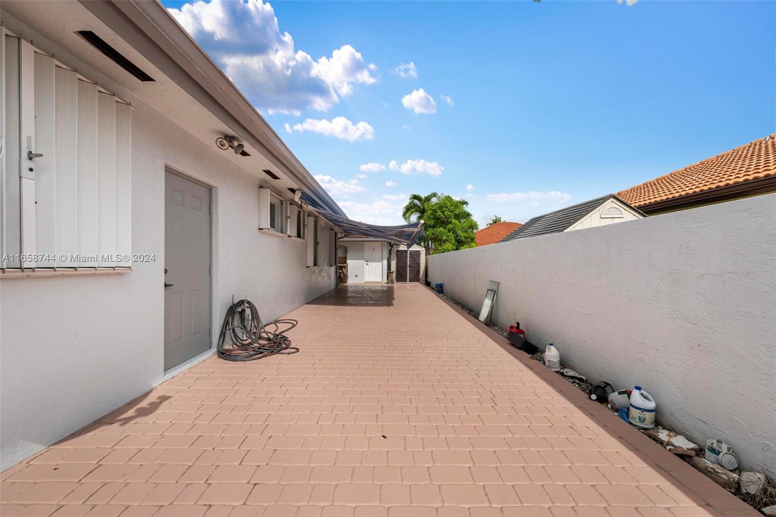 3209 Southwest 142nd Place Miami, FL 33175 - Photo 36 of 42 a backyard of a house with outdoor seating and trees