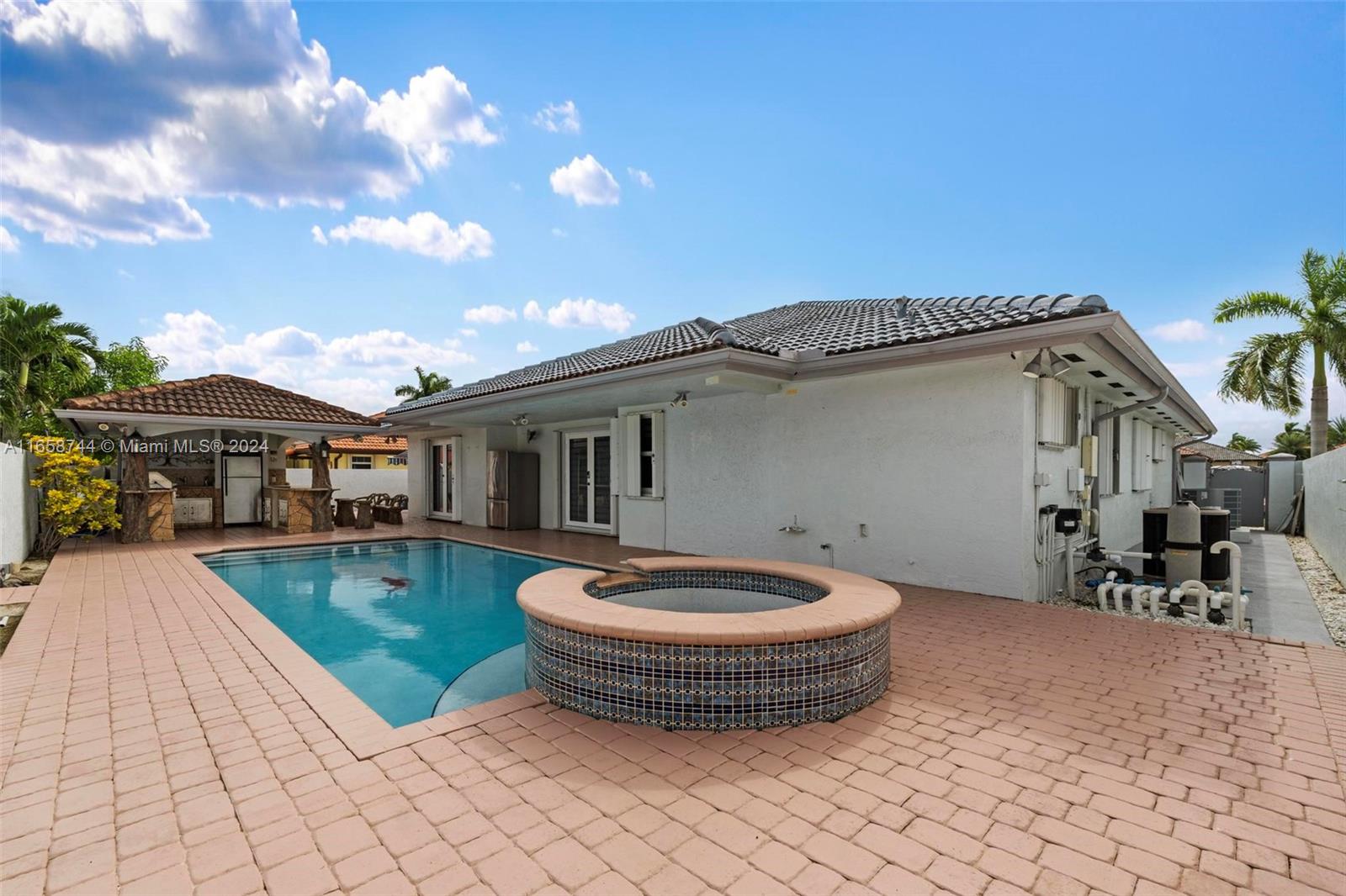 3209 Southwest 142nd Place Miami, FL 33175 - Photo 5 of 42 a view of a house with backyard sitting area and swimming pool