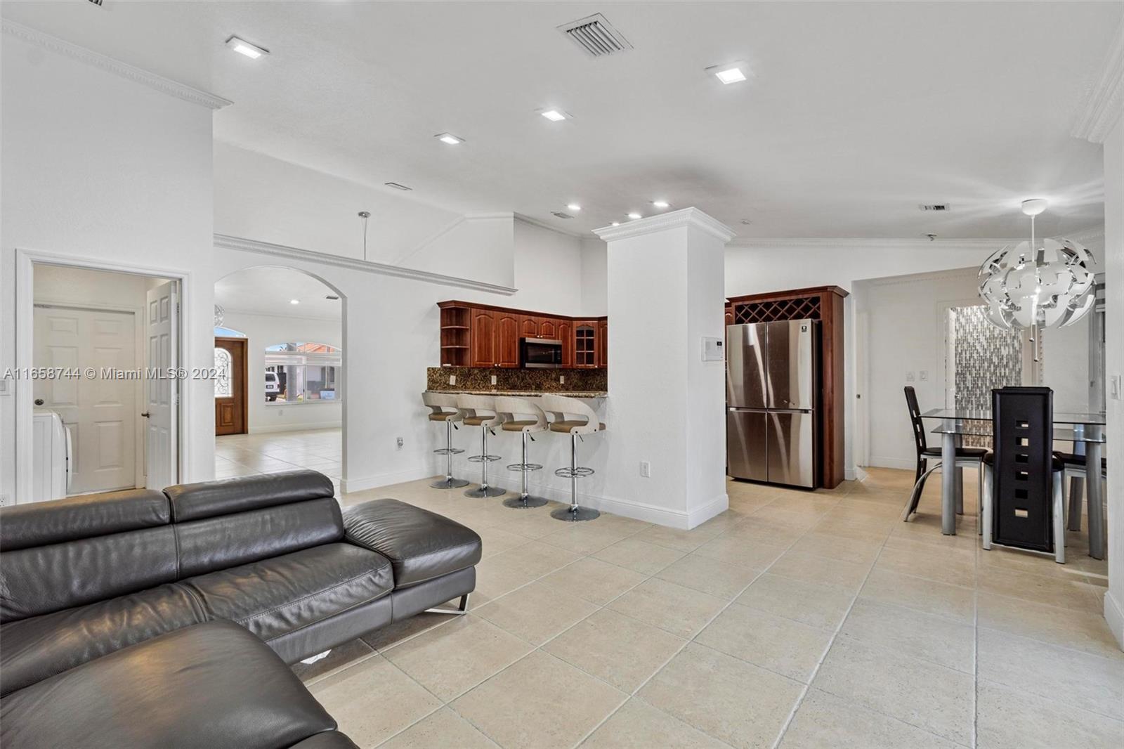3209 Southwest 142nd Place Miami, FL 33175 - Photo 10 of 42 a living room with furniture and a flat screen tv