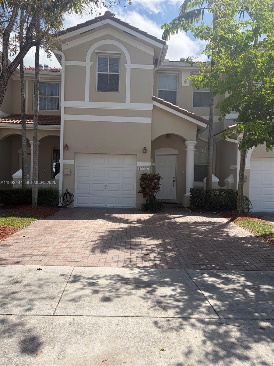 12398 Southwest 125th Terrace Miami, FL 33186 - Photo 1 of 45 a front view of a house with a yard and garage