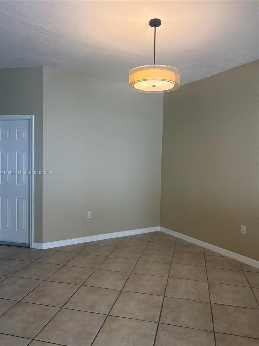 12398 Southwest 125th Terrace Miami, FL 33186 - Photo 13 of 45 a view of a room with a chandelier fan and window