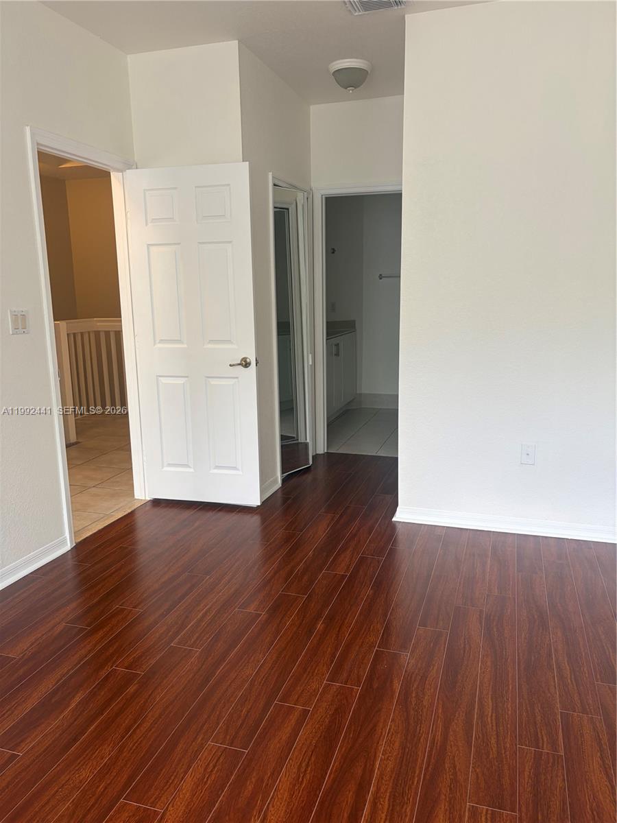 12398 Southwest 125th Terrace Miami, FL 33186 - Photo 22 of 45 an empty room with wooden floor and closet