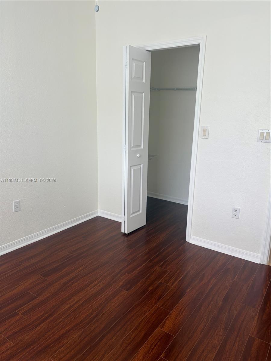 12398 Southwest 125th Terrace Miami, FL 33186 - Photo 31 of 45 an empty room with wooden floor and closet