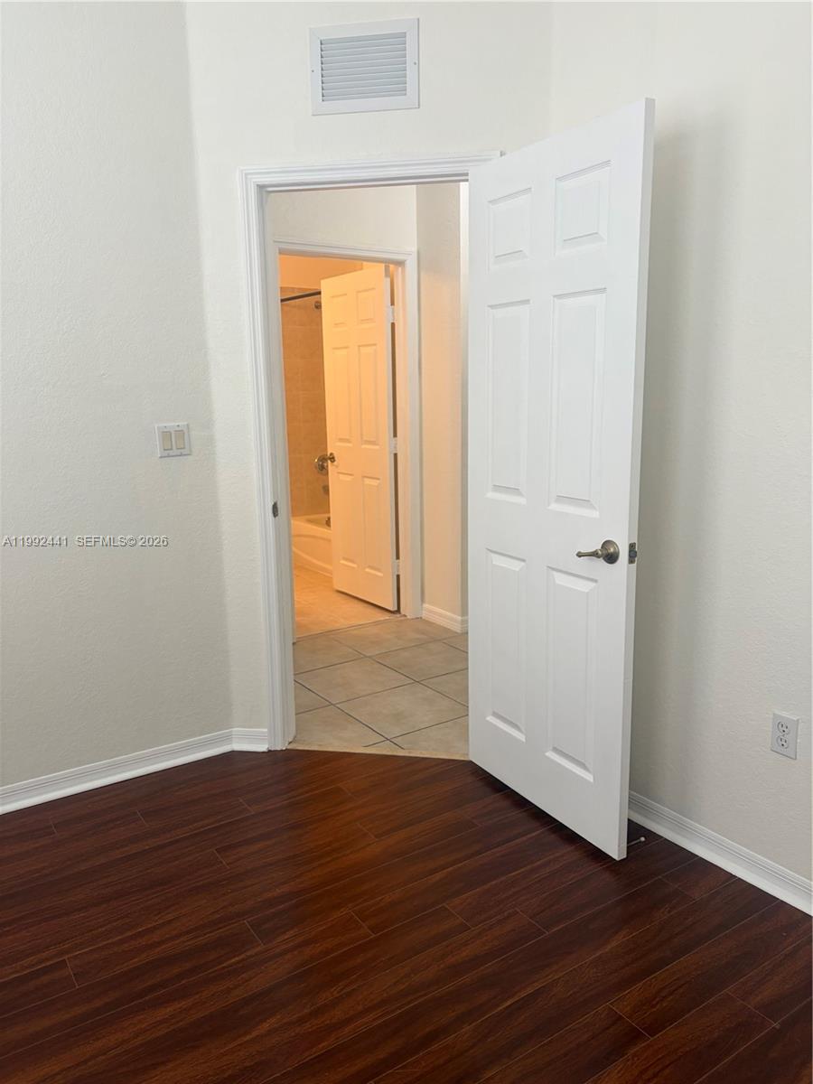 12398 Southwest 125th Terrace Miami, FL 33186 - Photo 37 of 45 an empty room with wooden floor and closet