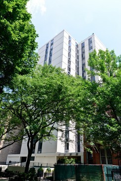 a front view of a building with trees