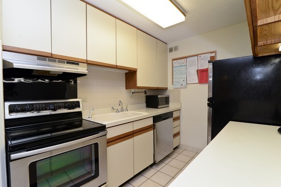 1339 North Dearborn Street, Unit 4H Chicago, IL 60610 - Photo 5 of 13 a kitchen with a stove and a microwave