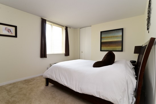 1339 North Dearborn Street, Unit 4H Chicago, IL 60610 - Photo 7 of 13 a bedroom with a bed and a window
