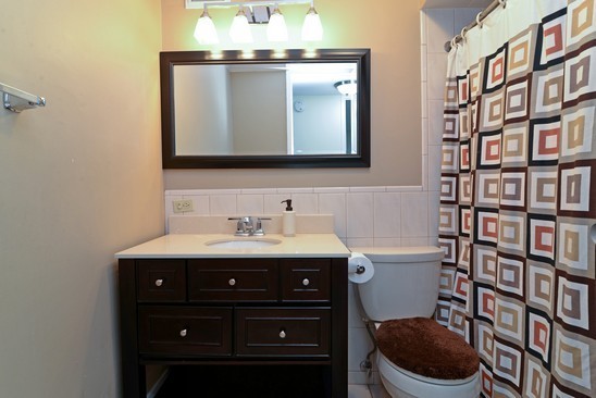 1339 North Dearborn Street, Unit 4H Chicago, IL 60610 - Photo 9 of 13 a bathroom with a toilet sink and mirror