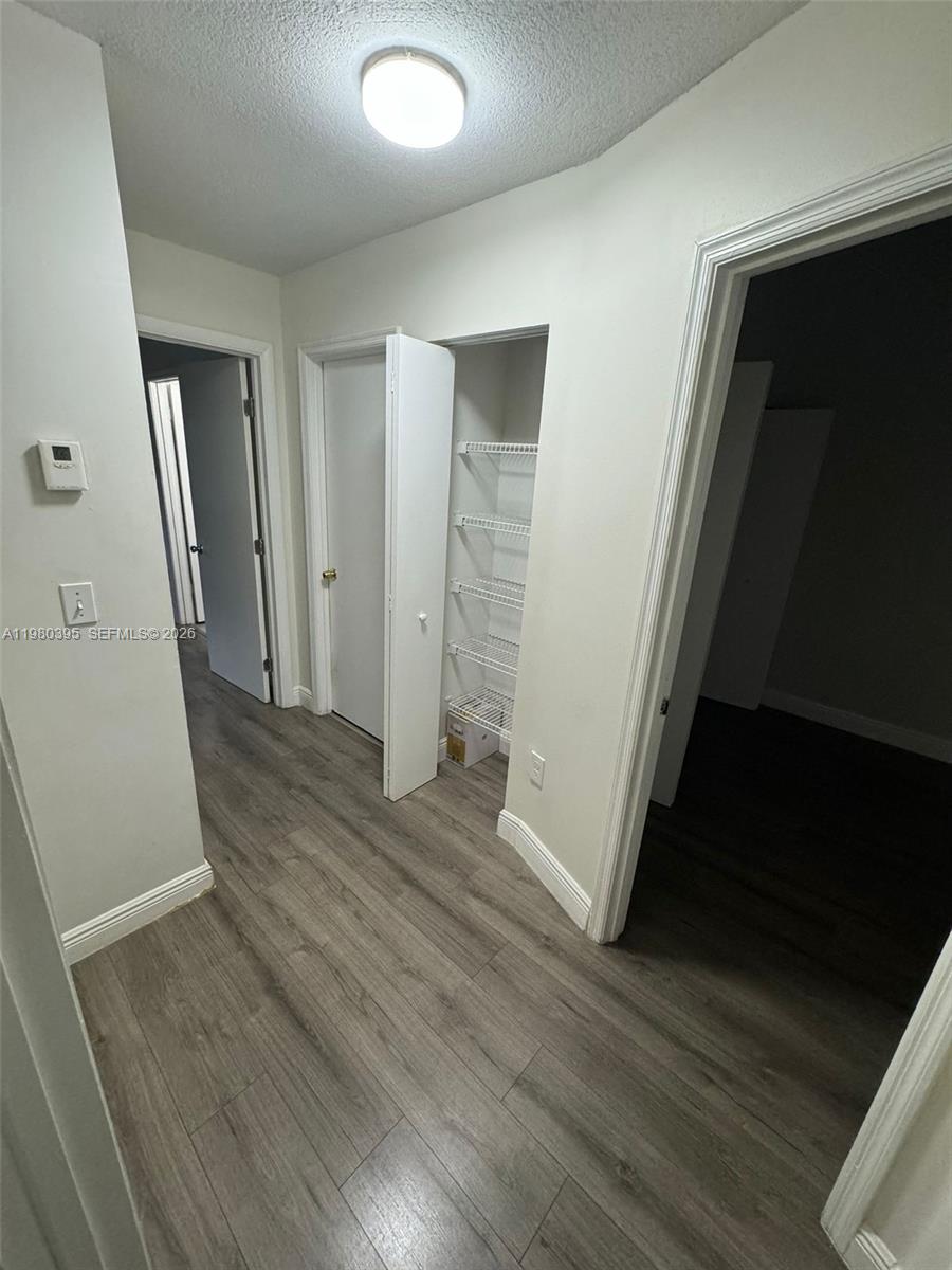 6235 Southwest Kendale Lakes Circle, Unit 237 Miami, FL 33183 - Photo 16 of 24 an empty room with wooden floor and windows