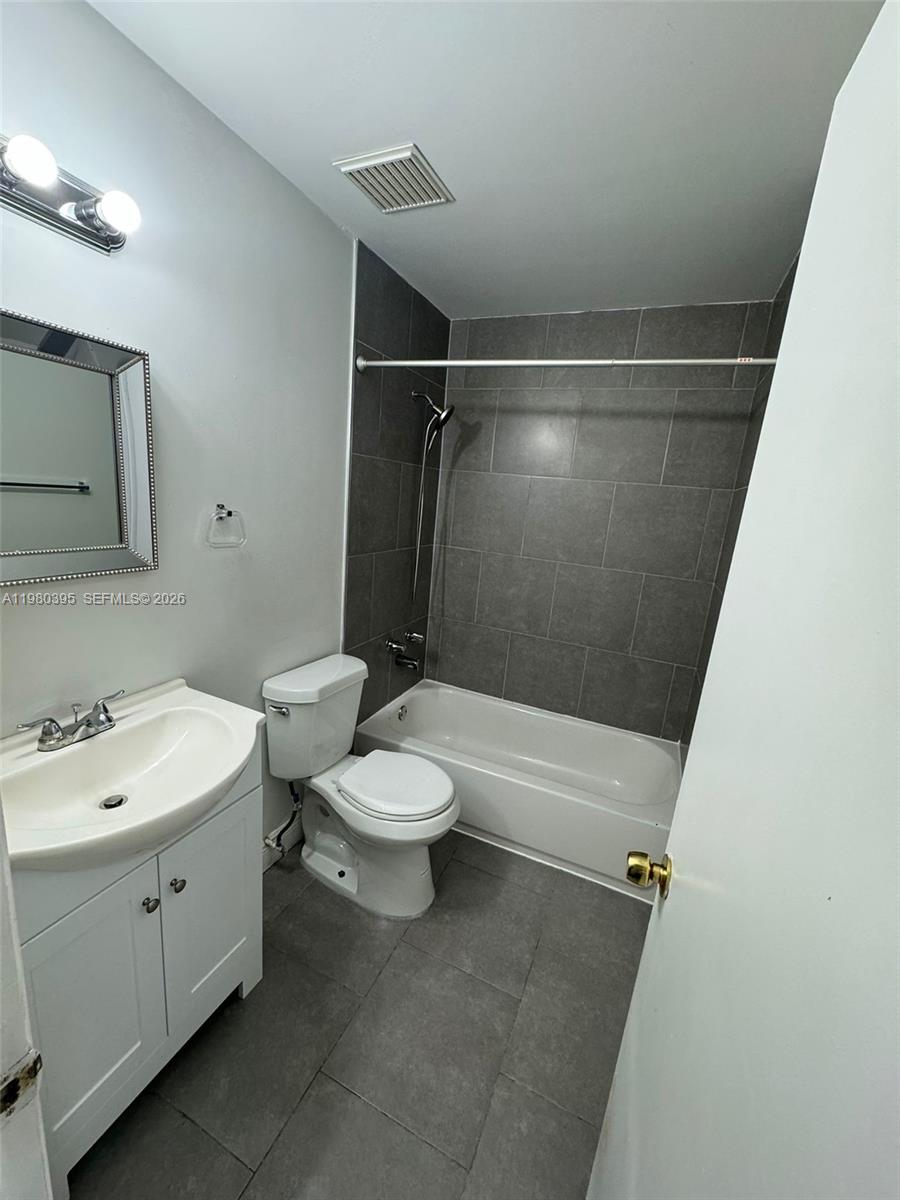 6235 Southwest Kendale Lakes Circle, Unit 237 Miami, FL 33183 - Photo 19 of 24 a bathroom with a toilet sink and shower