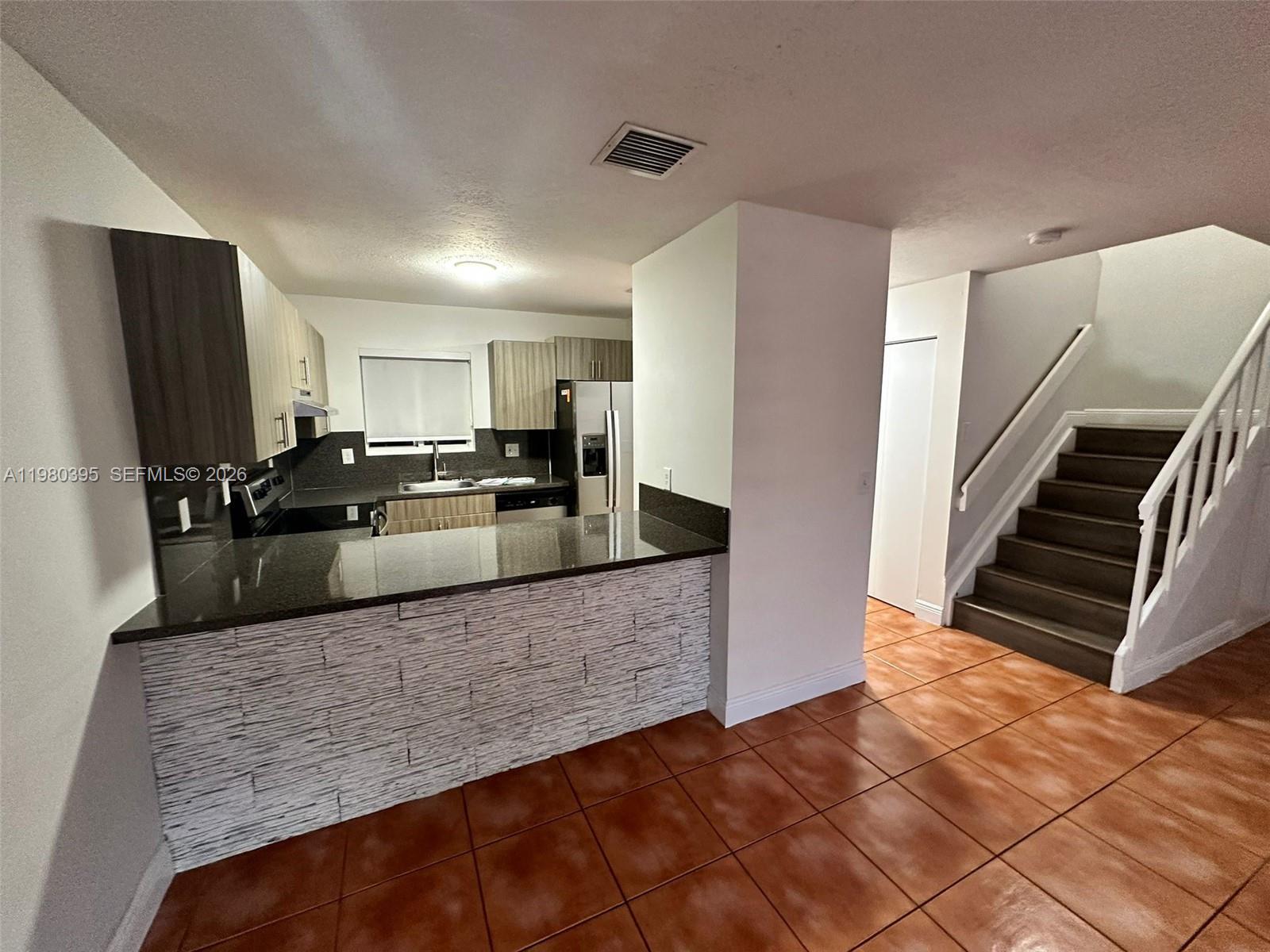 6235 Southwest Kendale Lakes Circle, Unit 237 Miami, FL 33183 - Photo 4 of 24 a large kitchen with a stove a refrigerator and a sink