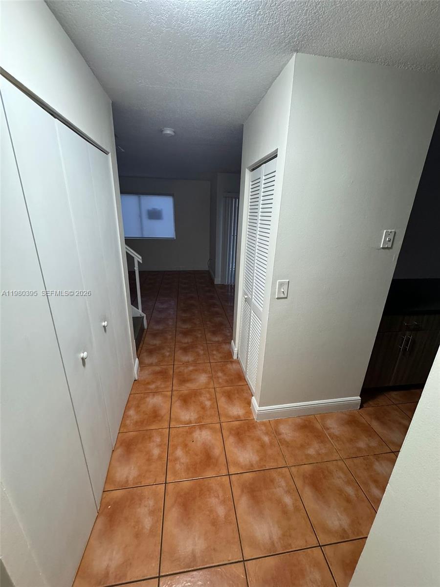 6235 Southwest Kendale Lakes Circle, Unit 237 Miami, FL 33183 - Photo 7 of 24 a view of entryway with a rug and a floor to ceiling window