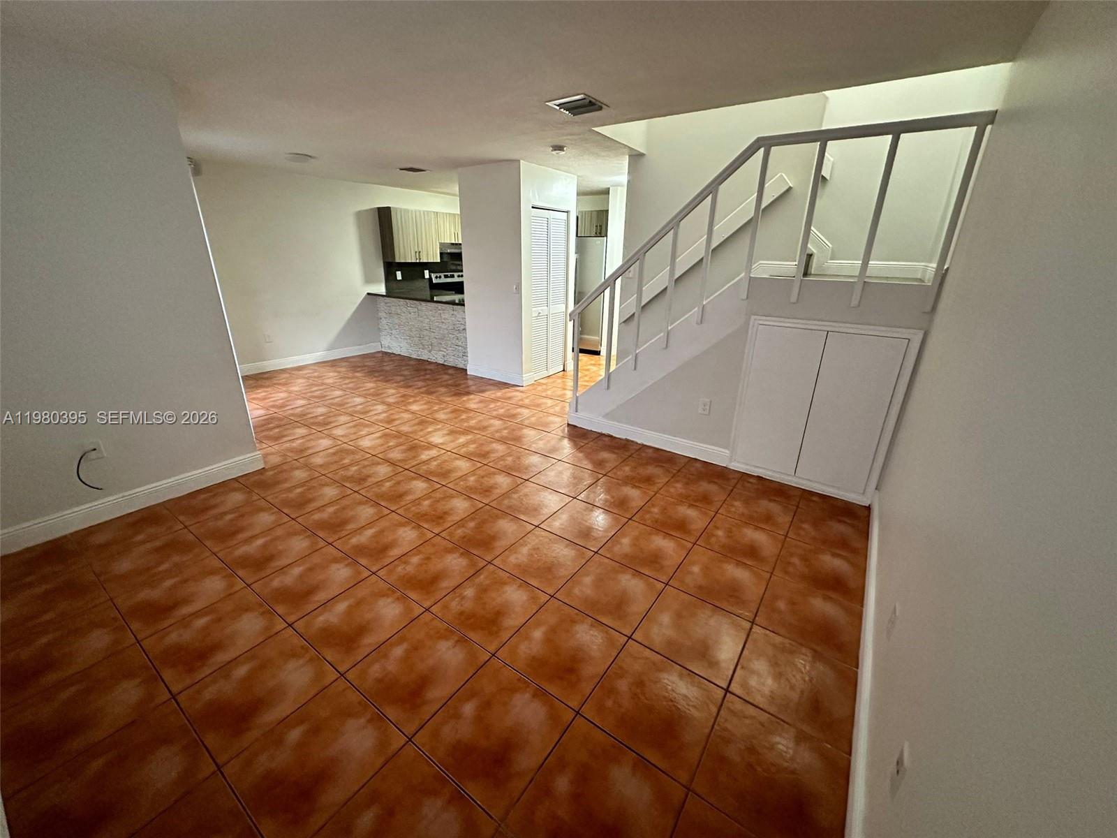 6235 Southwest Kendale Lakes Circle, Unit 237 Miami, FL 33183 - Photo 9 of 24 a view of a hallway view with wooden floor and staircase