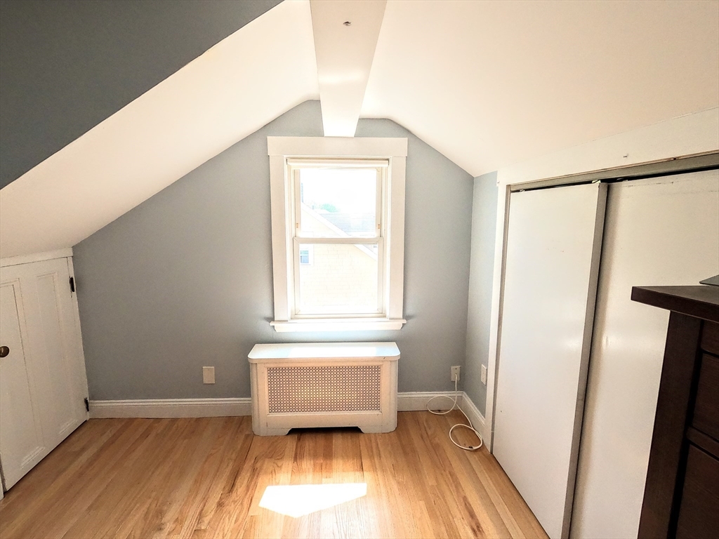 12 Searle Road, Unit 12 Boston, MA 02132 - Photo 30 of 35 a view of a room with wooden floor and white walls