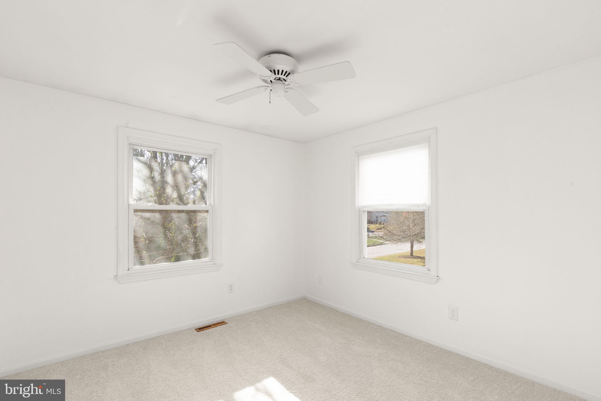 4802 Variation Road Nottingham, MD 21236 - Photo 21 of 32 an empty room with a window and a ceiling fan