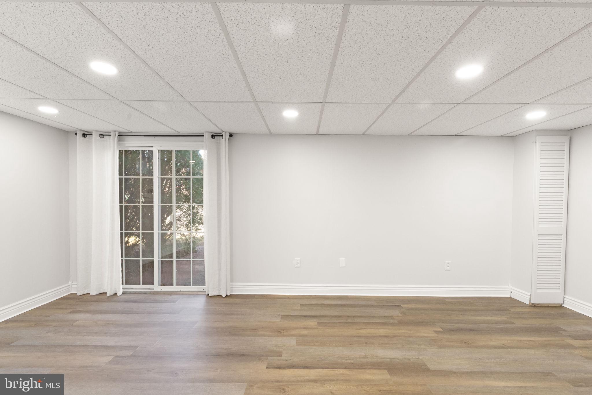 4802 Variation Road Nottingham, MD 21236 - Photo 23 of 32 a view of an empty room with wooden floor and a window