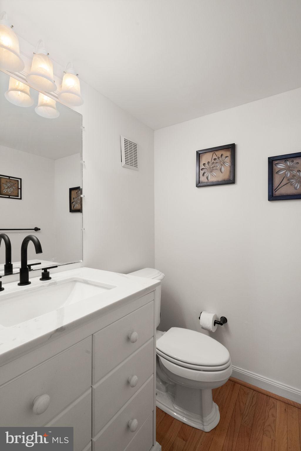 4802 Variation Road Nottingham, MD 21236 - Photo 7 of 32 a bathroom with a toilet a sink and mirror