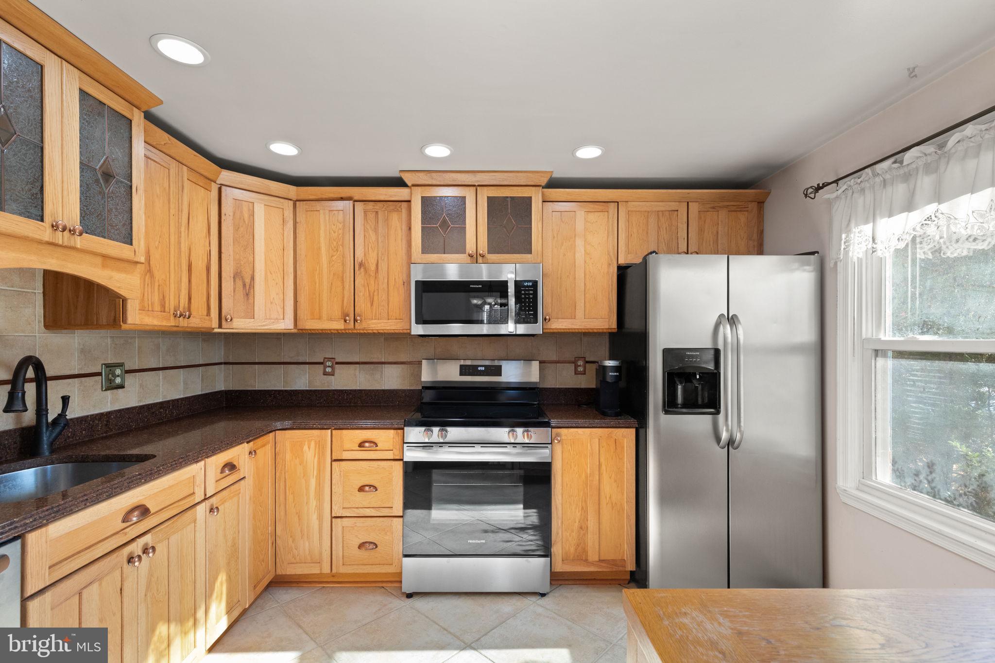4802 Variation Road Nottingham, MD 21236 - Photo 10 of 32 a kitchen with stainless steel appliances granite countertop a refrigerator and a sink