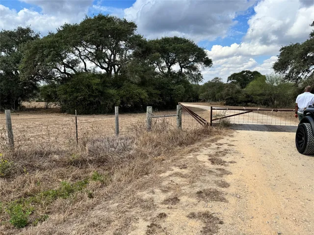 a view of a backyard with wooden fence