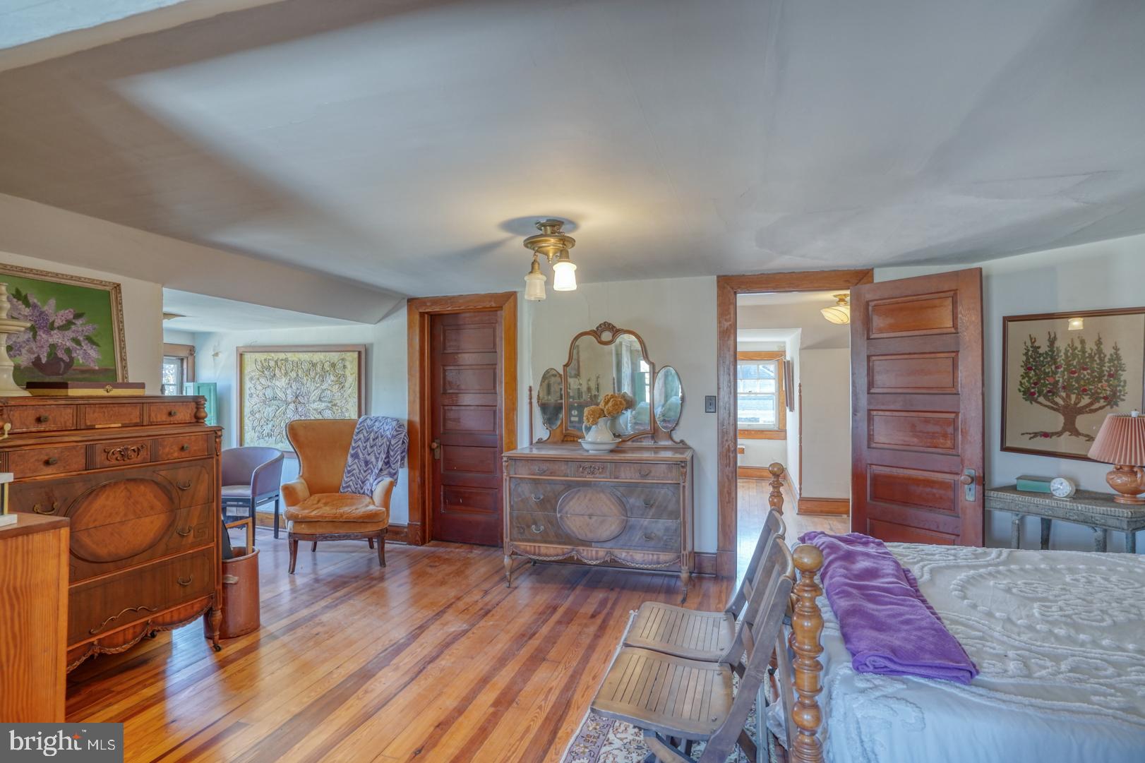 4096 Main Street Trappe, MD 21673 - Photo 59 of 70 a bedroom with a bed and wooden floor