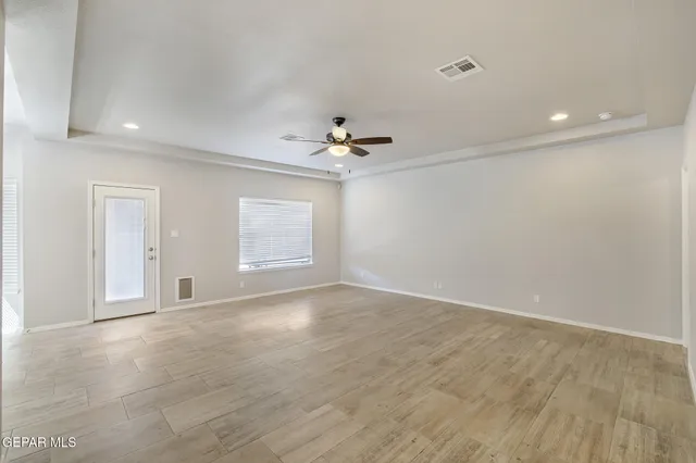 wooden floor in an empty room with a window