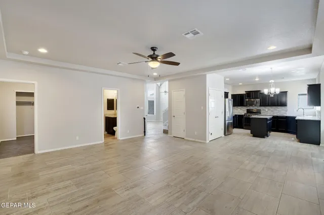 a view of an empty room with a kitchen