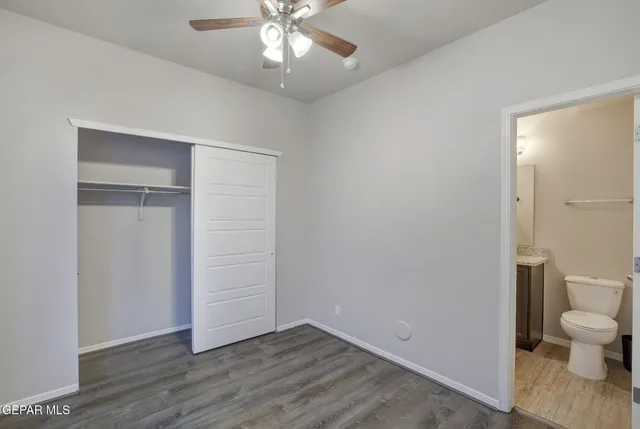 wooden floor in an empty room with a bathroom