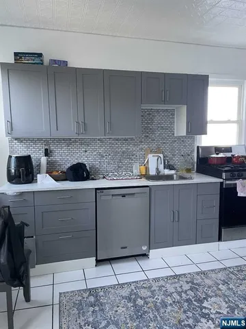 a kitchen with stainless steel appliances granite countertop a sink and cabinets