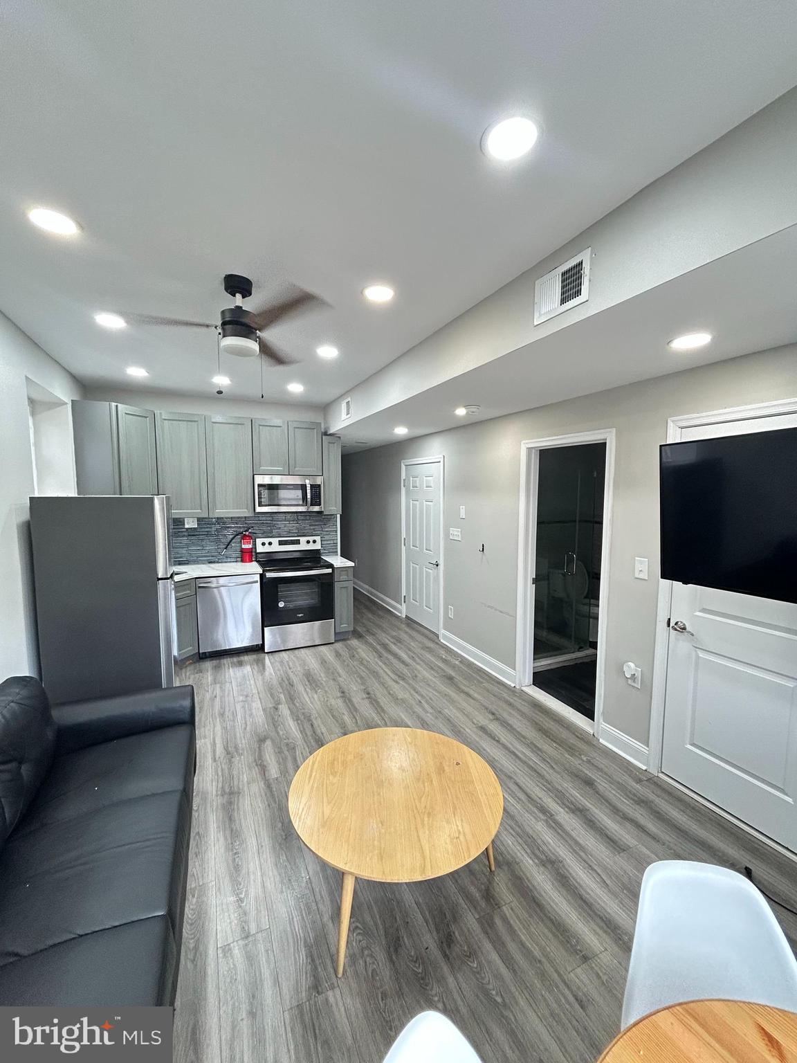2417 North 54th Street, Unit D Philadelphia, PA 19131 - Photo 4 of 13 a living room with stainless steel appliances furniture and a wooden floor