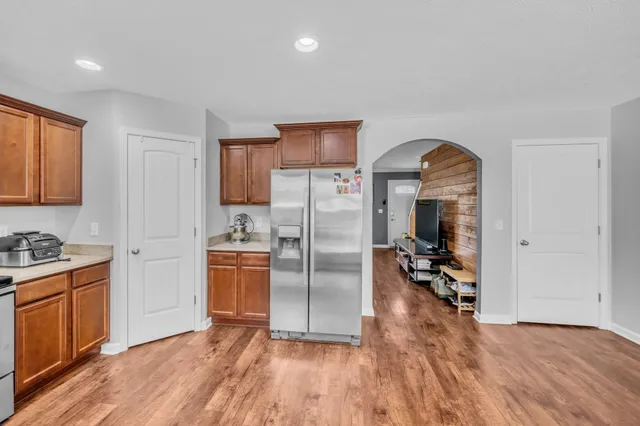 a kitchen with stainless steel appliances granite countertop a refrigerator and a stove top oven