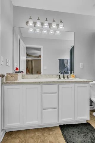 a bathroom with a sink vanity and mirror