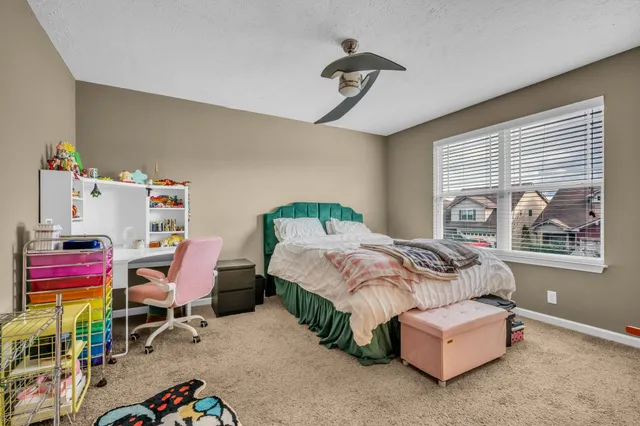 a bedroom with bed and a book shelf