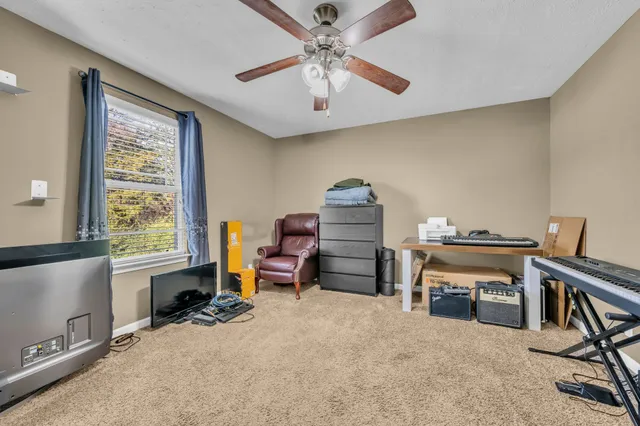 a bedroom with furniture and a window