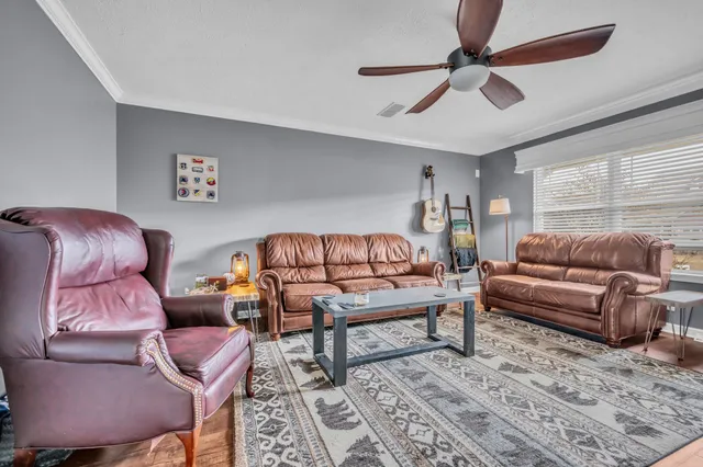 a living room with furniture and a rug