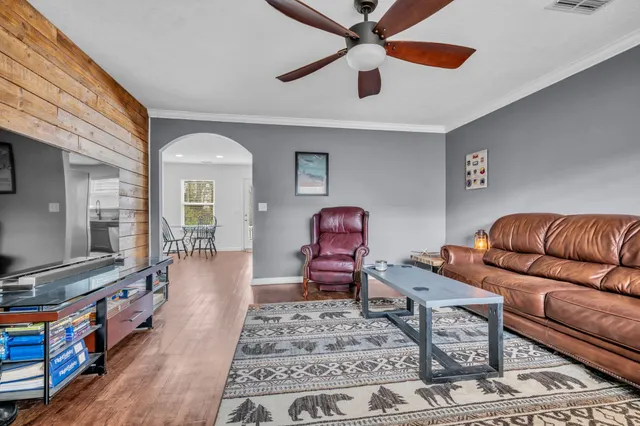 a living room with furniture and wooden floor