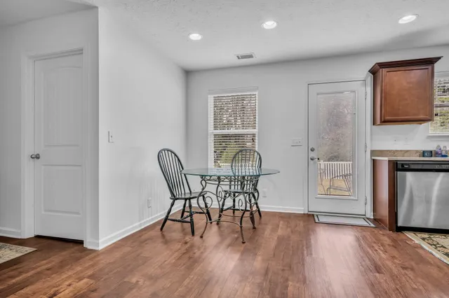 a view of a dining room with furniture and wooden floor