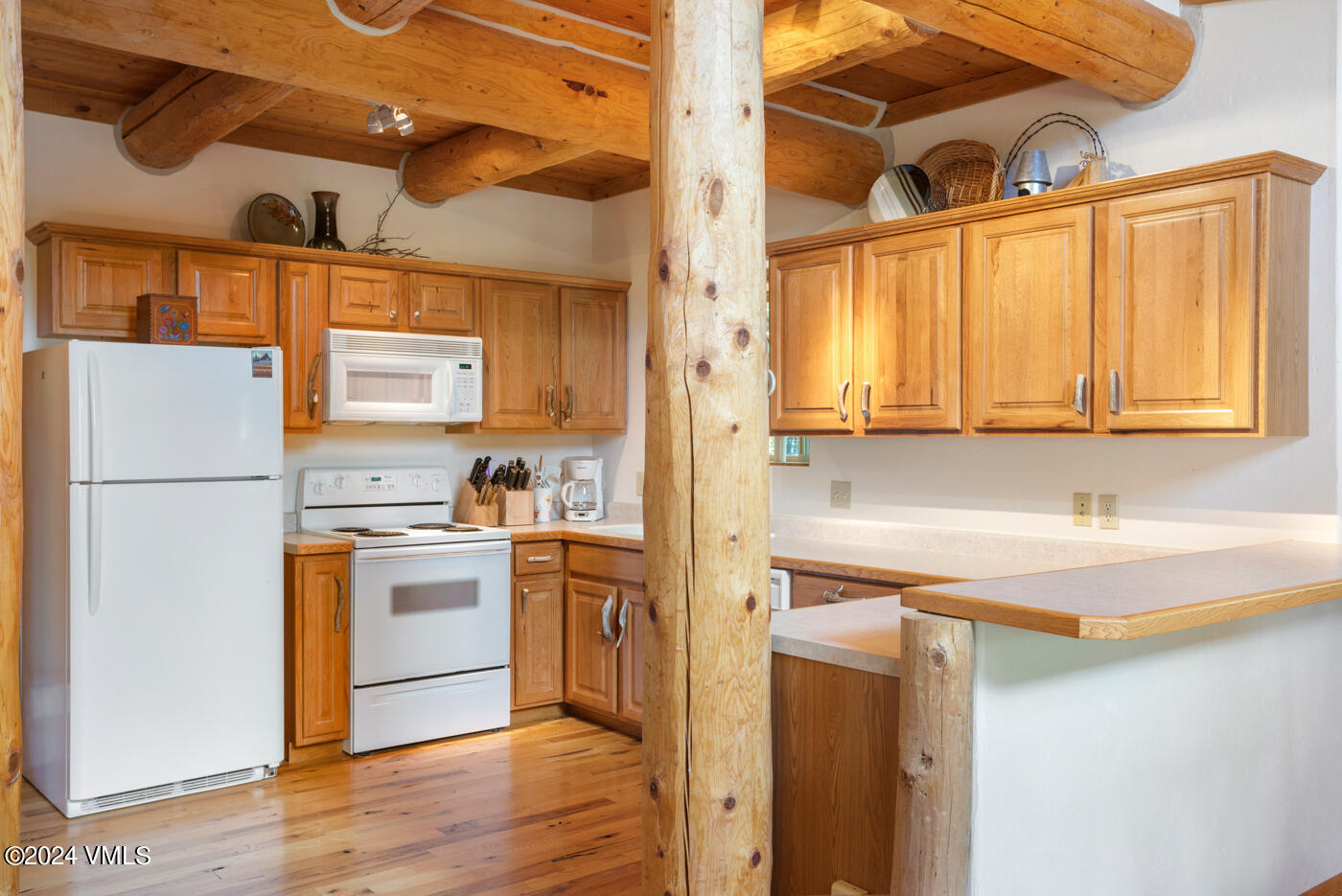 150 County Road Gypsum, CO 81637 - Photo 24 of 43 a kitchen with stainless steel appliances granite countertop a refrigerator a sink dishwasher a stove with cabinets and wooden floor
